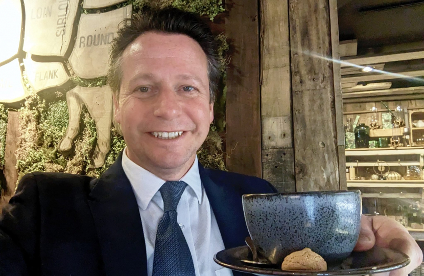 Nigel Huddleston holding a cup of coffee