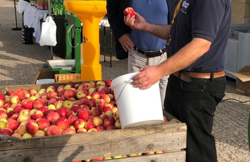 Nigel Huddleston MP presses first apple at Pershore College community day.