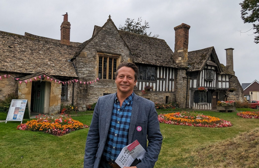 An image of Nigel Huddleston MP standing outside the Almonry in Evesham.