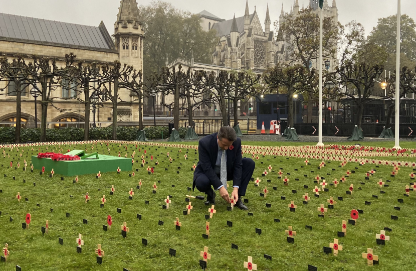 Nigel Huddleston MP plants a cross in the 'Constituency Garden of Remembrance' at the Houses of Parliament.