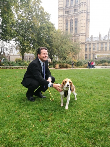 Nigel Huddleston with Dogs Trust Puppy outside parliament