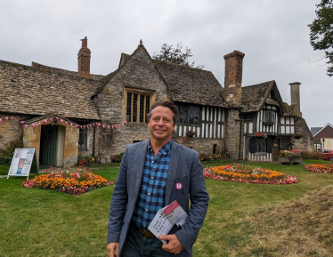 An image of Nigel Huddleston MP standing outside the Almonry in Evesham.