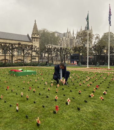 Nigel Huddleston MP plants a cross in the 'Constituency Garden of Remembrance' at the Houses of Parliament.